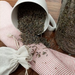 lavender flowers in a cup and on the table