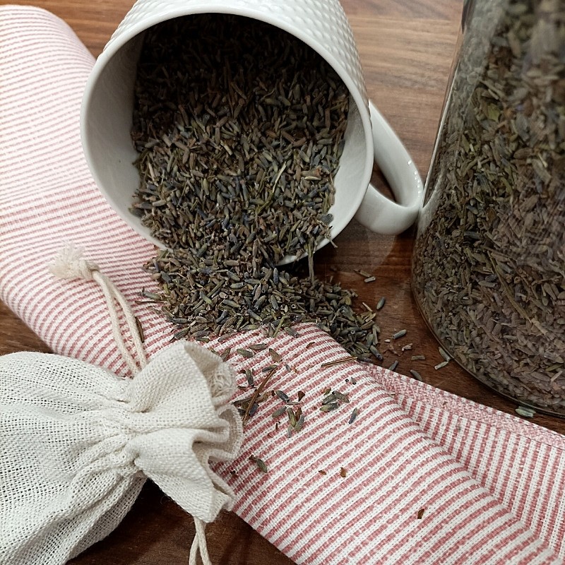 lavender flowers in a cup and on the table lavender flowers in a cup and on the table