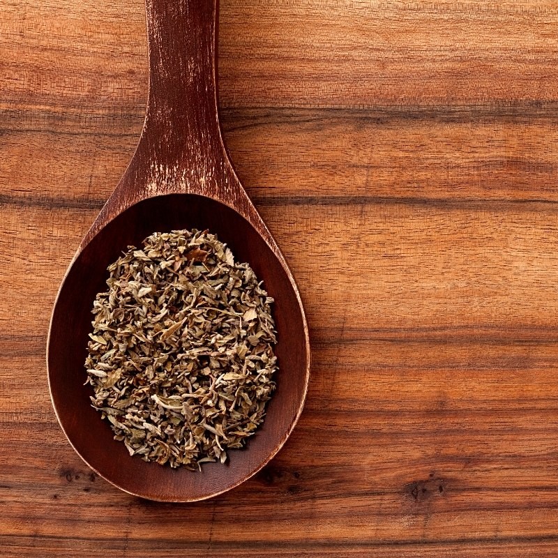 damiana leaves in a wooden spoon damiana leaves in a wooden spoon