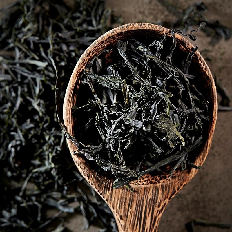 dried seaweed in a wooden spoon and on the table