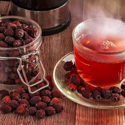 hawthorn berries in a jar and next to a tea