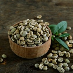 green coffee beans in a cup and on the table