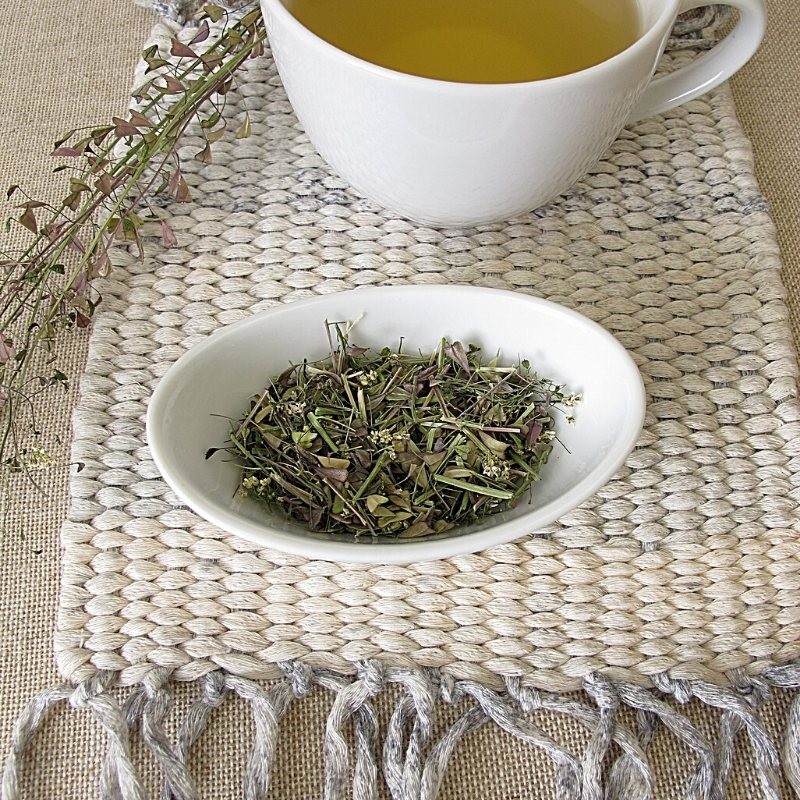 dried Shepherd's Purse on a plate next to a tea