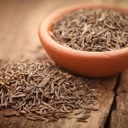 caraway seeds in a bowl and on a table