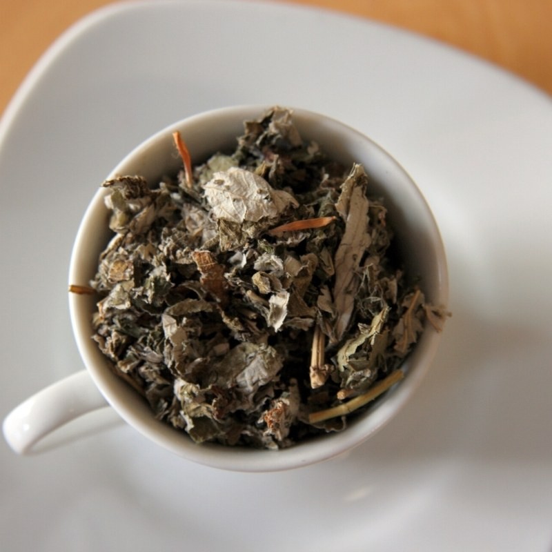 Raspberry leaves in a cup on a plate