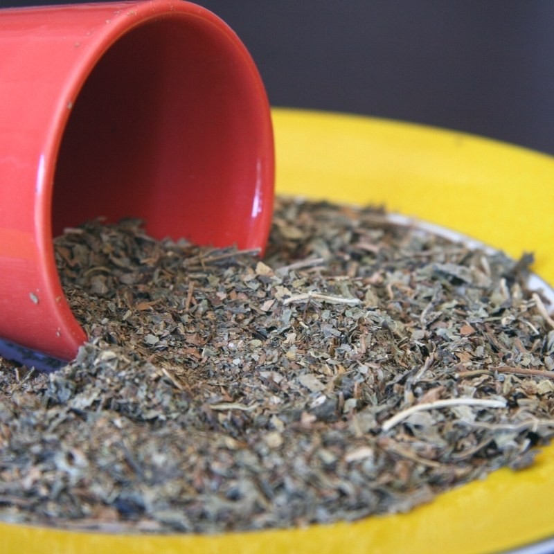 papaya leaves in a cup spilled onto a plate